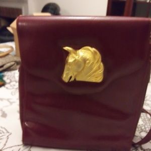 Brown purse with horse head madalio on front closu